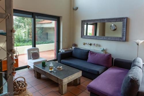 a living room with a couch and a table at Theo Pool Villa Magnificent Sea View in Kapandrítion