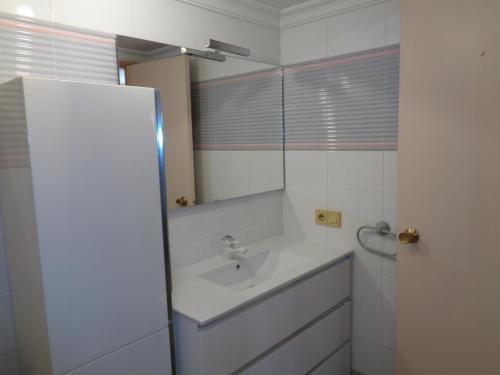 a bathroom with a sink and a mirror at Edificio Calpemar in Calpe