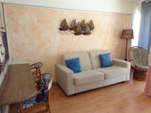 a living room with a couch and some shoes on the wall at Edificio Calpemar in Calpe