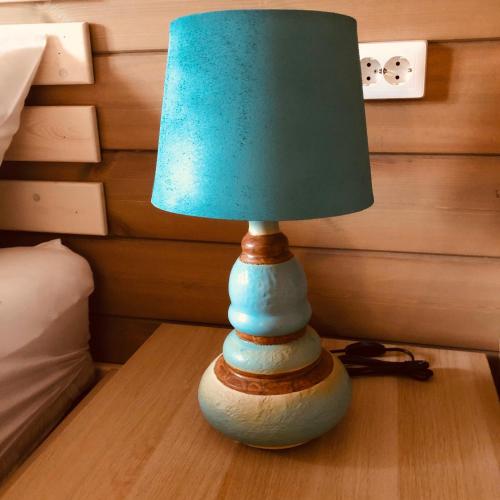 a lamp sitting on top of a wooden table at Club Thermal Village Cegled in Cegléd