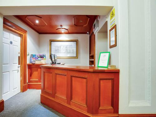 a room with a reception desk in a hospital room at Lost Guest House Stirling in Stirling