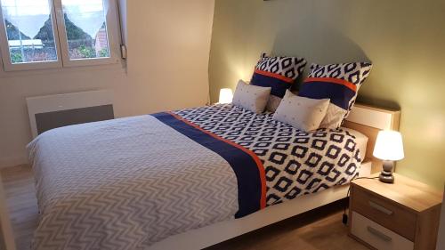 ein Schlafzimmer mit einem großen Bett mit Kissen in der Unterkunft Gite D'Elnon-Libre in Saint-Amand-les-Eaux