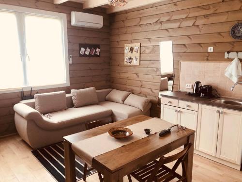 a living room with a couch and a table at Club Thermal Village Cegled in Cegléd