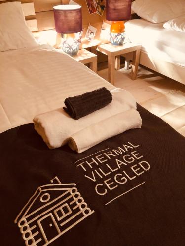 a bed with two towels on top of it at Club Thermal Village Cegled in Cegléd