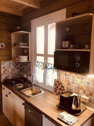 a kitchen with a sink and a counter top at Club Thermal Village Cegled in Cegléd