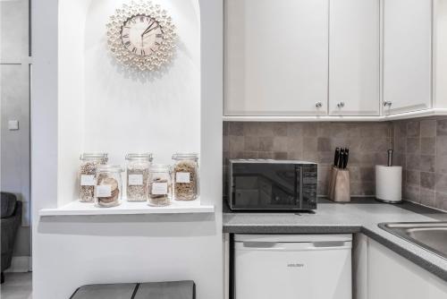 a kitchen with white cabinets and a microwave at Ice Cream Suite in Edinburgh