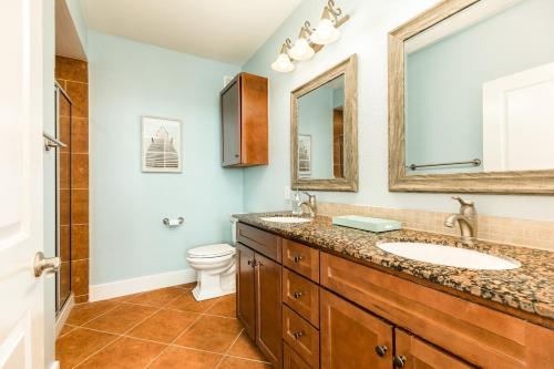 a bathroom with a sink and a toilet at Sandpiper Point in Galveston