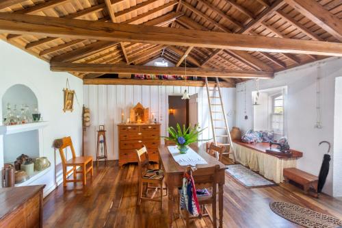 a living room with a table and chairs and a couch at Quinta Do Martelo in Angra do Heroísmo