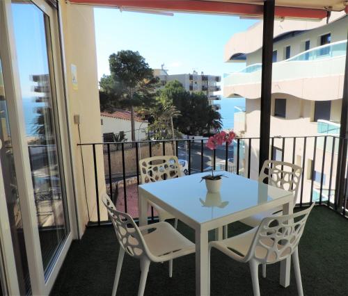 a white table and chairs on a balcony at Apartment in Salou next to the beach for families,WIFI in Salou