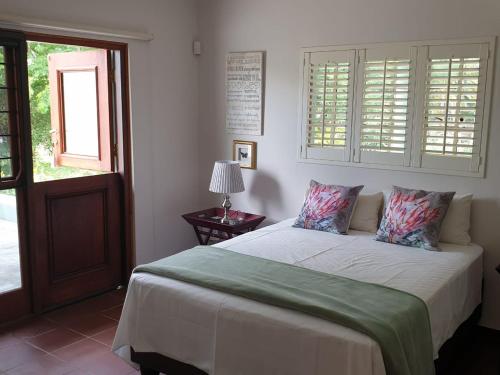 a bedroom with a bed and a window at Kruger Allo View B&B in Komatipoort