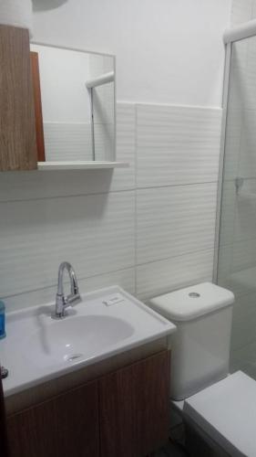 a white bathroom with a sink and a toilet at POUSADA LOS AMIGOS CAMPECHE in Florianópolis