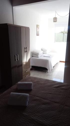a bedroom with a bed and a large window at POUSADA LOS AMIGOS CAMPECHE in Florianópolis