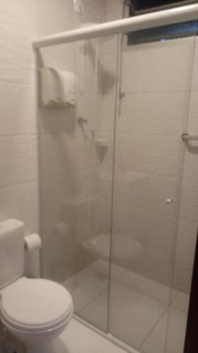 a bathroom with a toilet and a glass shower at POUSADA LOS AMIGOS CAMPECHE in Florianópolis
