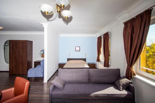 a living room with a couch and a bed at Apartamenty Wratislavia in Wrocław