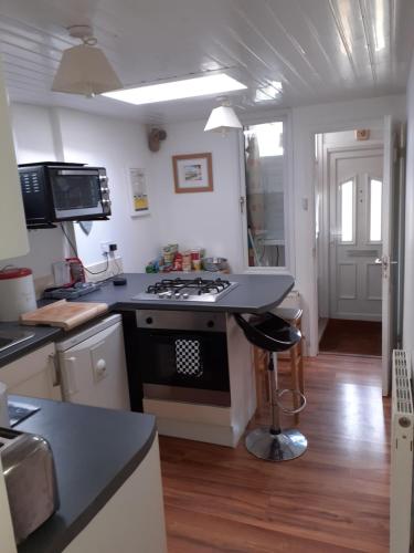 a kitchen with a black and white stove top oven at The Get Away in Margate