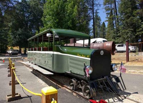 a green train is sitting on the tracks at Northern Queen Inn in Nevada City