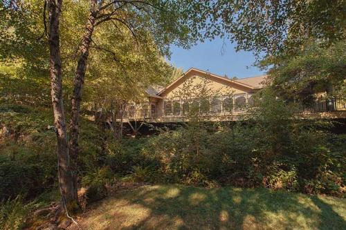 a house with a bridge in front of a yard at Northern Queen Inn in Nevada City