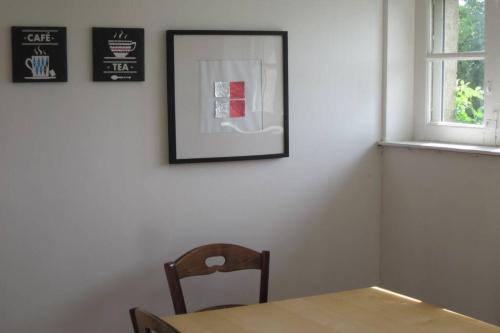 a dining room with a table and a picture on the wall at AMBOISE, maison de charme au calme in Nazelles