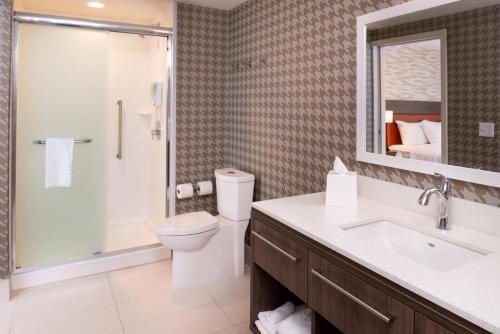 a bathroom with a toilet and a shower and a sink at Home2 Suites By Hilton Columbus/West, OH in Columbus
