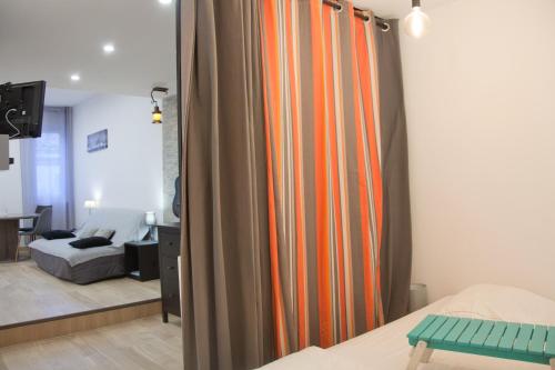 a room with a bed and a curtain in a room at Le Poilu 40 m2 in La Ciotat