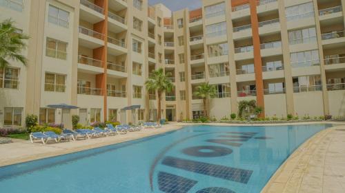 a swimming pool in front of a building at Rivoli Suites in Hurghada