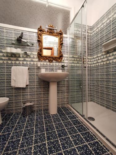 a bathroom with a sink and a mirror and a shower at La Luna sul Porto in Santa Margherita Ligure