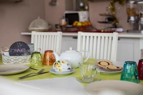 a table with a tea pot and dishes on it at Villa La Baia a pochi passi dal lago in San Felice del Benaco