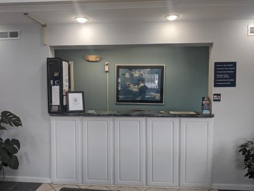 a counter in a room with a sign on the wall at Key West Inn - Childersburg in Childersburg