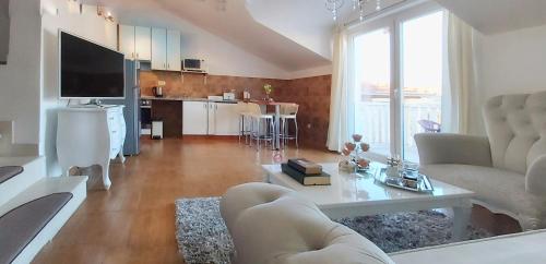 a living room with a couch and a table at Adria Apartments and Rooms in Dubrovnik