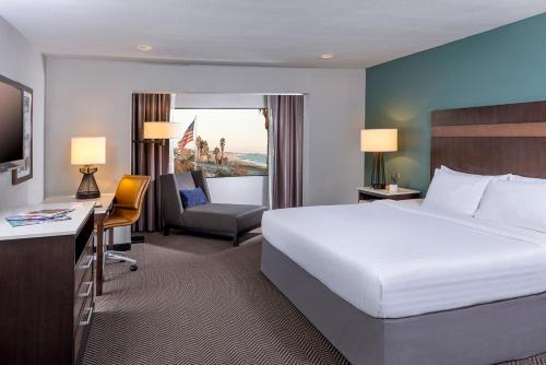 a hotel room with a large bed and a desk at The Pierpont Inn in Ventura