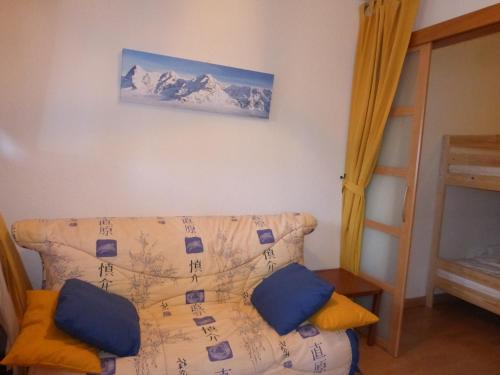 a living room with a couch and a picture on the wall at CREPUSCULE 11 in Le Sauze