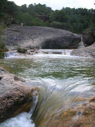 a river with rapids on the rocks and water at Cal Tomas, Ecoturisme Terra Alta in Bot