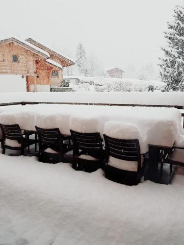 a row of benches covered in snow at Superbe chalet-11 personnes-Chamonix(Les Bossons) in Chamonix-Mont-Blanc