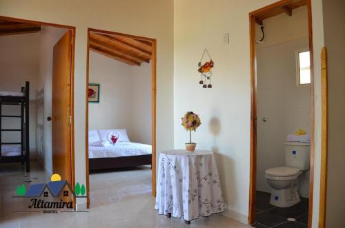a bathroom with a toilet and a table in a room at Altamira Biohotel in Socorro