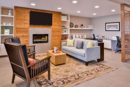 a living room with a couch and a tv at Country Inn & Suites by Radisson, Ft Atkinson, WI in Fort Atkinson