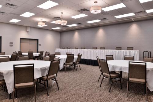 a conference room with tables and chairs and a chalkboard at Country Inn & Suites by Radisson, Ft Atkinson, WI in Fort Atkinson