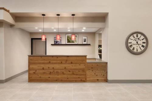 a large clock on a wall next to a lobby at Country Inn & Suites by Radisson, Ft Atkinson, WI in Fort Atkinson