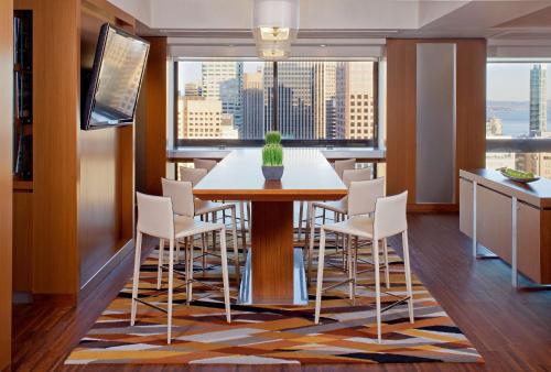 a dining room with a table and white chairs at Grand Hyatt San Francisco Union Square in San Francisco