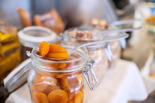 a mason jar filled with peeled oranges on a counter at Hotel Bacco Rooms and Breakfast in Pietra Ligure