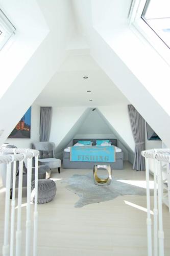 a bedroom with a bed in a attic at WellenRausch Living "Sonnendeck" in Travemünde