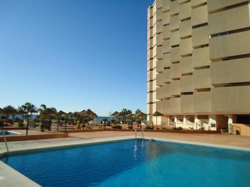 une piscine devant un immeuble dans l'établissement VICO Estudio con parking, à Almuñécar