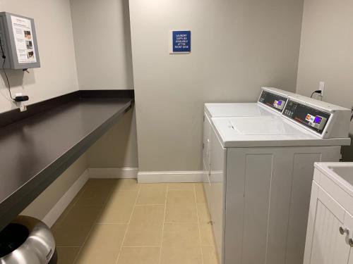 a bathroom with a sink and a washing machine at Best Western West Lebanon-Hanover in West Lebanon