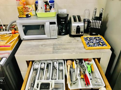a kitchen counter with a drawer full of utensils at Departamento Tu espacio Eje Central 100 y calle Moctezuma, Garibaldi-Lagunilla Subway-Station in Mexico City