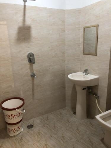 a bathroom with a sink and a toilet and a phone at Shine star BnB in Amritsar