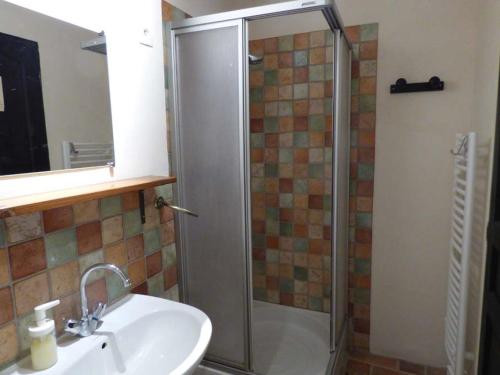 a bathroom with a shower and a sink and a sink at Le Relais des Baronnies in Montjay