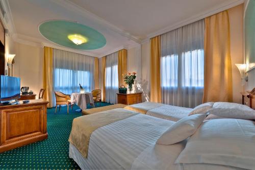 A bed or beds in a room at Hotel Terme Antoniano