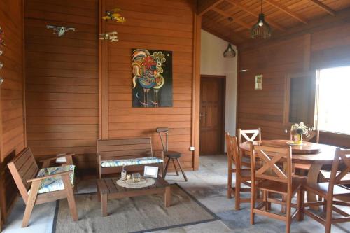 a dining room with a table and chairs at TROPICAL HOUSE ATINS in Atins