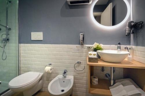a bathroom with a sink and a toilet and a mirror at B&B Sorrento Queen in Sorrento