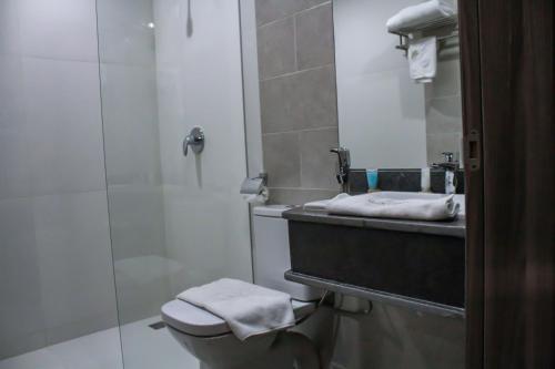 a bathroom with a shower and a toilet and a sink at SUNSET HOTEL in Nouakchott