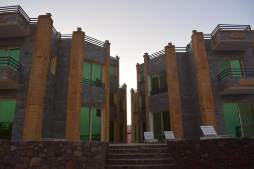 a row of buildings with chairs in front of them at Diamond Dahab House in Dahab